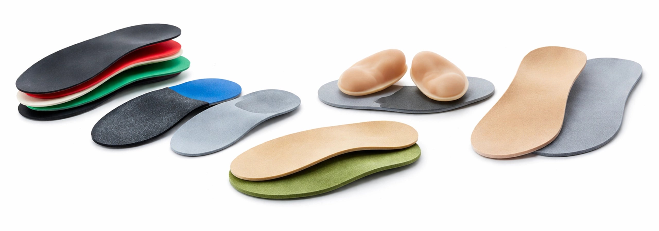 Set of different colored shoe insoles on a white background