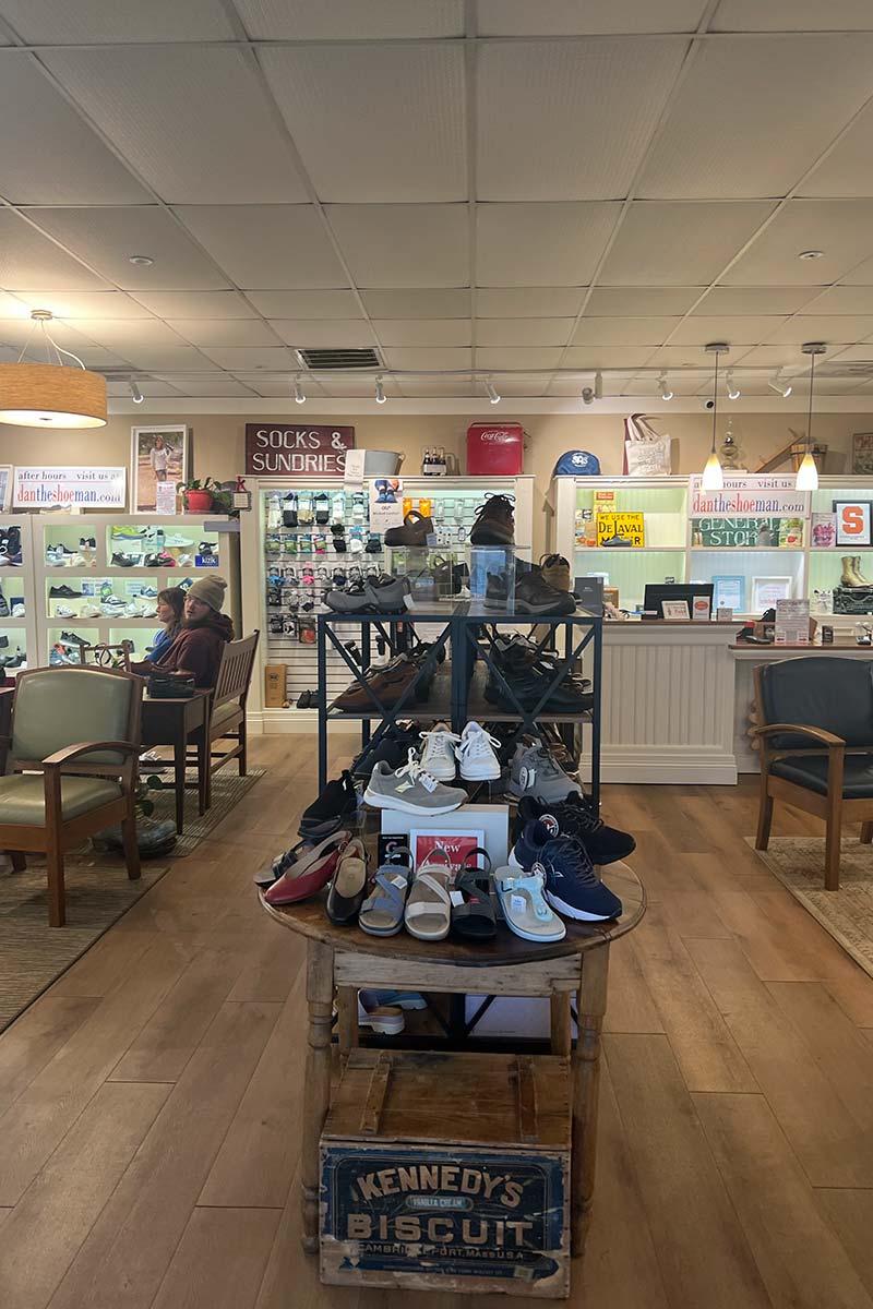 Shoe store interior with shoes on display and a counter.